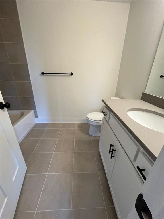 full bath featuring toilet, vanity, baseboards, and tile patterned floors