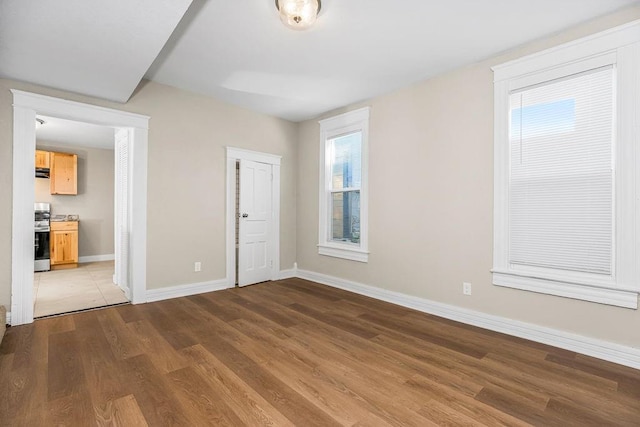 interior space with baseboards and wood finished floors