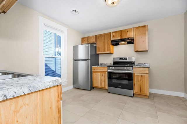 kitchen featuring under cabinet range hood, visible vents, appliances with stainless steel finishes, and baseboards