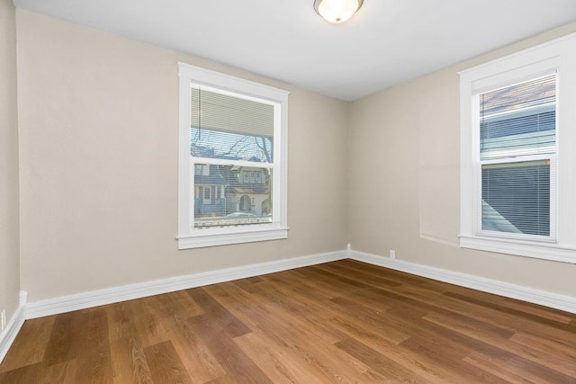 empty room with wood finished floors and baseboards