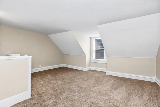 bonus room featuring carpet, baseboards, and vaulted ceiling