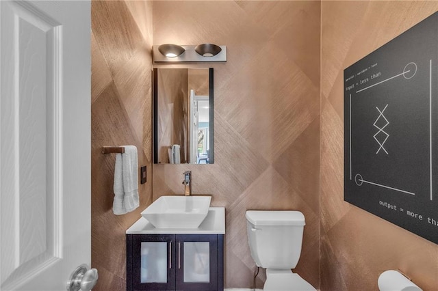 half bathroom featuring toilet and vanity