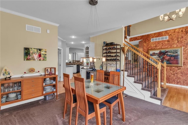 dining area with ornamental molding, stairway, a chandelier, carpet flooring, and baseboards