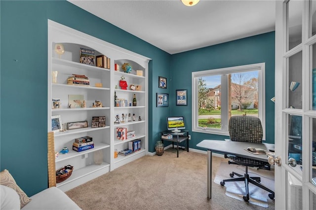 carpeted home office with baseboards