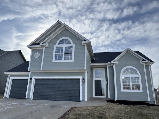 view of front of home featuring a garage, concrete driveway, and roof with shingles