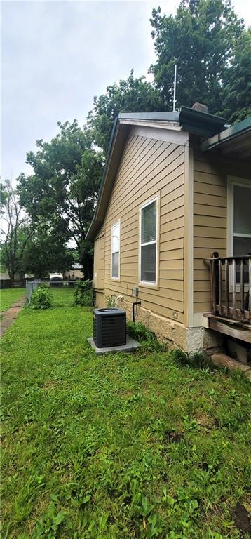 408 W Peoria St, Paola, KS 66071 - view of property exterior with central air condition unit and a yard