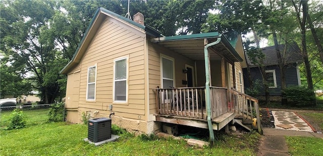 408 W Peoria St, Paola, KS 66071 - view of side of home with central air condition unit and a chimney