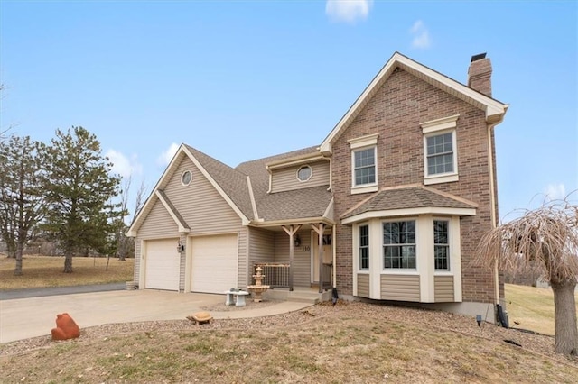 traditional home with brick siding, driveway, a chimney, and a garage