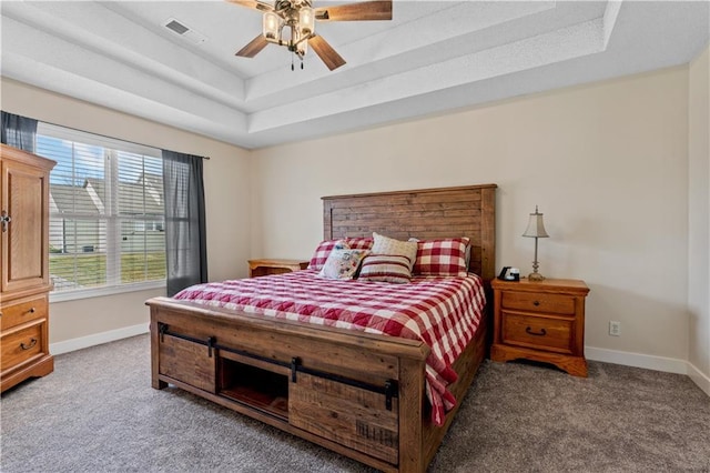 bedroom featuring a raised ceiling, carpet, baseboards, and visible vents