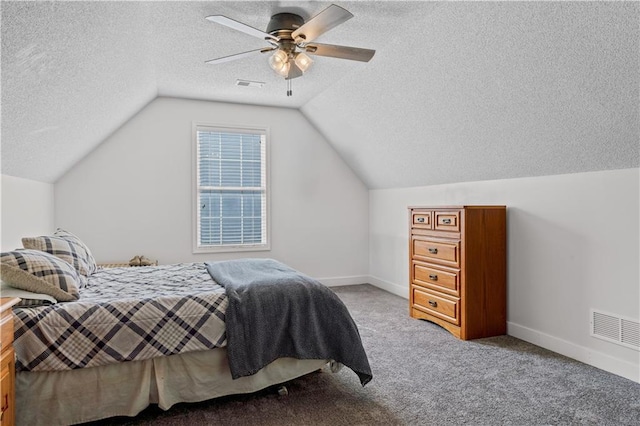 bedroom featuring visible vents, carpet floors, a textured ceiling, and lofted ceiling