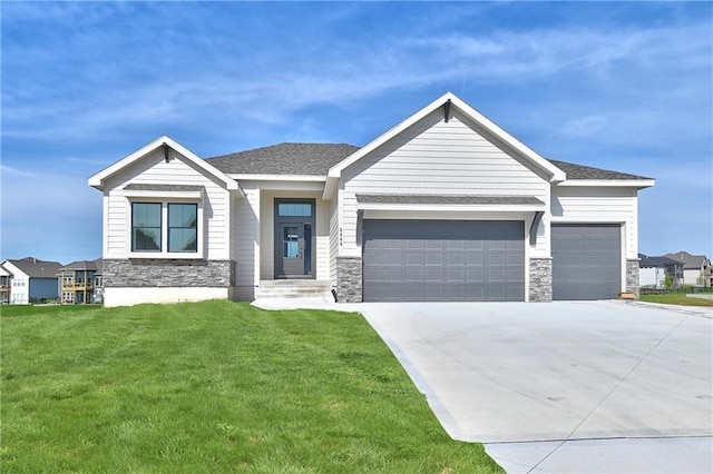 view of front of home with an attached garage, stone siding, and concrete driveway