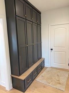 mudroom featuring light wood-type flooring and baseboards