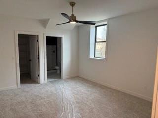 unfurnished bedroom featuring carpet, baseboards, and ensuite bathroom