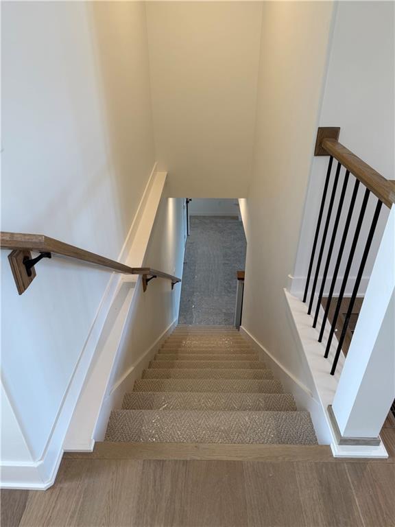 stairway featuring baseboards