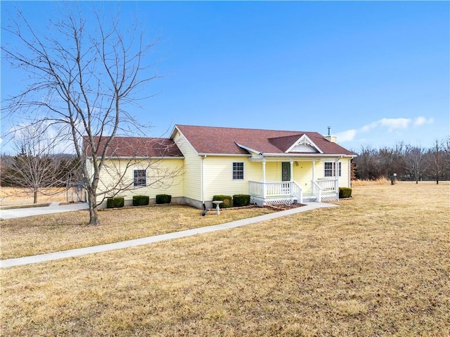 ranch-style home featuring a porch and a front lawn