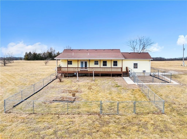 rear view of house with a gate, fence, and a deck