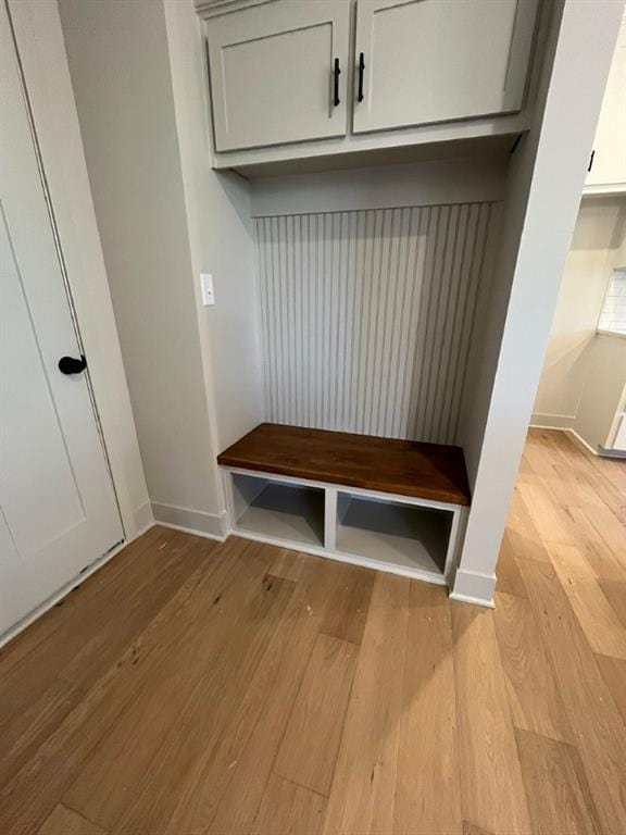 mudroom with light wood-style flooring and baseboards