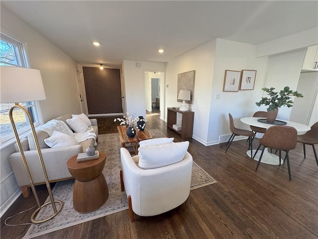 living room featuring dark wood-type flooring, recessed lighting, and baseboards