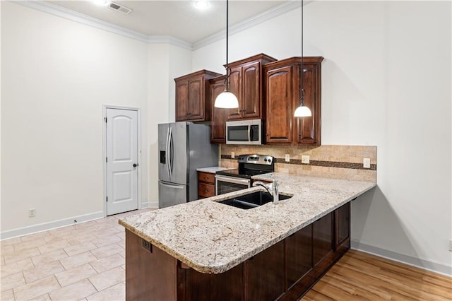 kitchen with stainless steel appliances, backsplash, ornamental molding, a sink, and a peninsula