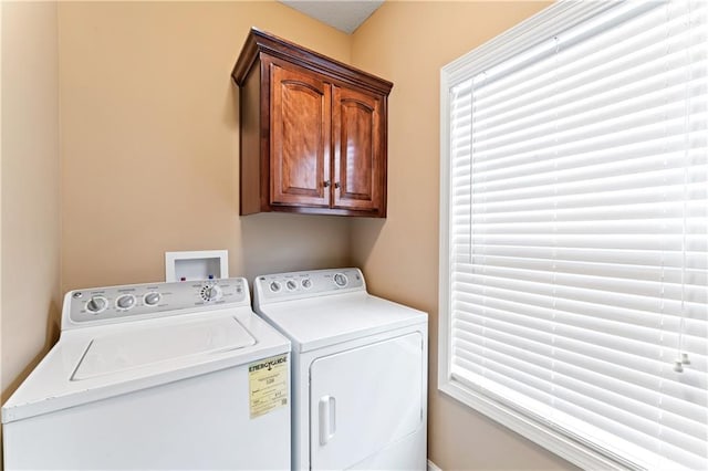 washroom with cabinet space and washer and dryer