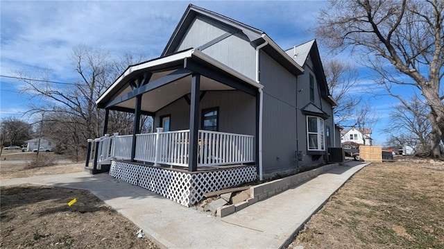 view of front of house with covered porch and central air condition unit