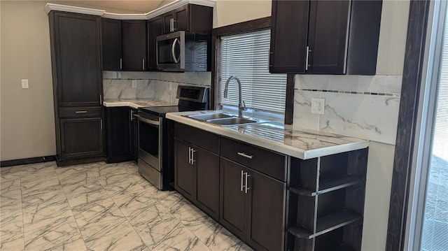 kitchen featuring appliances with stainless steel finishes, marble finish floor, light countertops, open shelves, and a sink