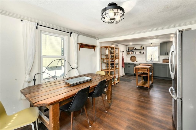 dining area with dark wood finished floors and a textured ceiling