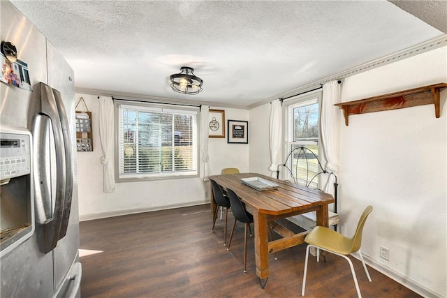 dining area with dark wood-style floors, ornamental molding, a textured ceiling, and baseboards