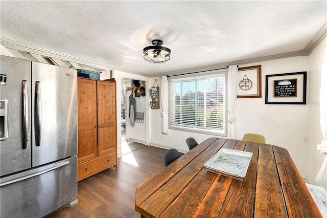 unfurnished dining area featuring ornamental molding, dark wood-style flooring, and a textured ceiling