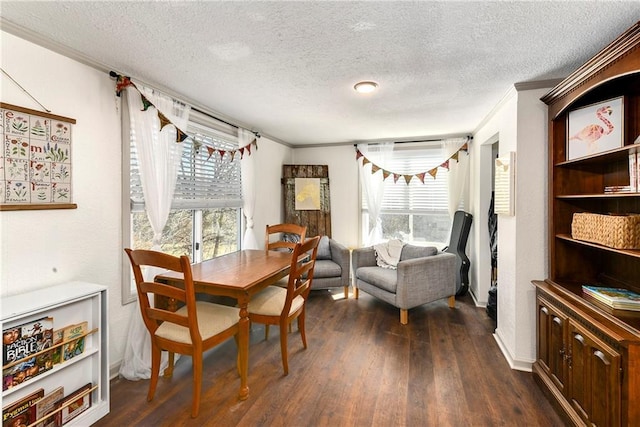 dining area featuring dark wood-style floors, a textured ceiling, and a healthy amount of sunlight