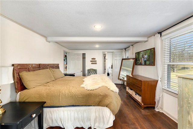 bedroom featuring dark wood-style floors and beam ceiling