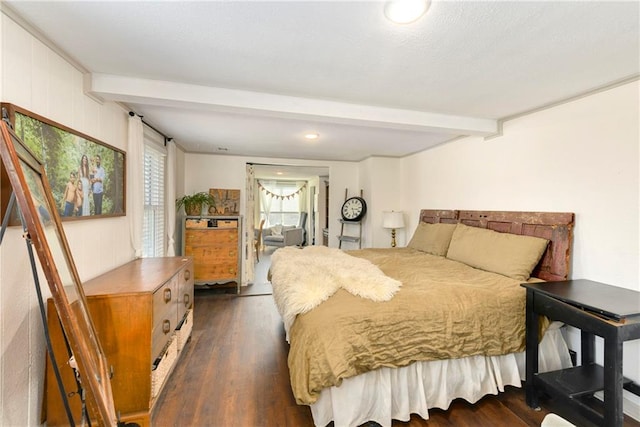 bedroom with dark wood-style flooring and beamed ceiling