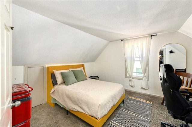 carpeted bedroom with lofted ceiling and a textured ceiling