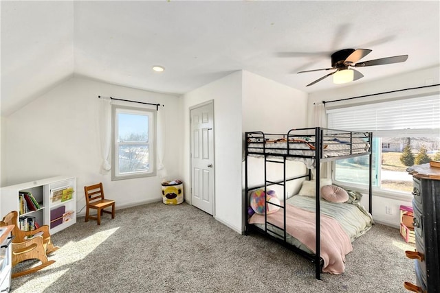 carpeted bedroom featuring a ceiling fan, vaulted ceiling, and baseboards