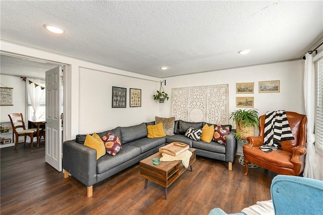 living room featuring recessed lighting, a textured ceiling, and wood finished floors