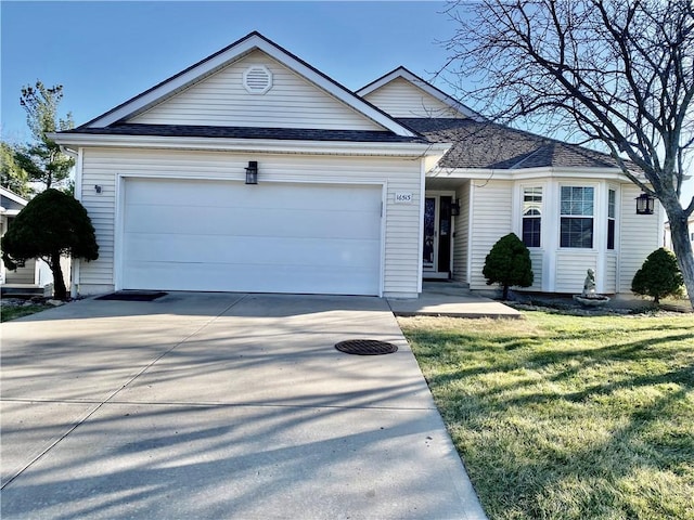 ranch-style home with concrete driveway, an attached garage, a front yard, and a shingled roof