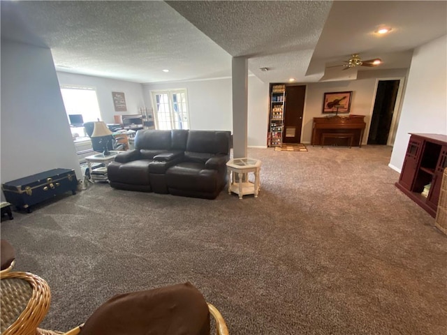 living room featuring carpet and a textured ceiling