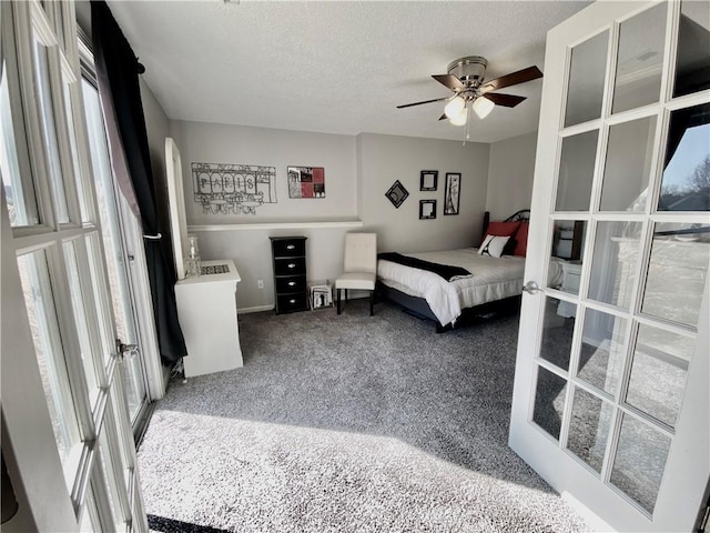 carpeted bedroom with french doors and a textured ceiling