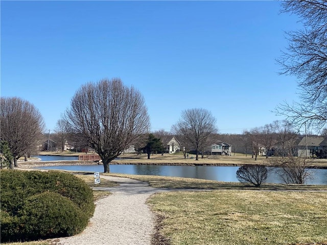 surrounding community with a yard and a water view