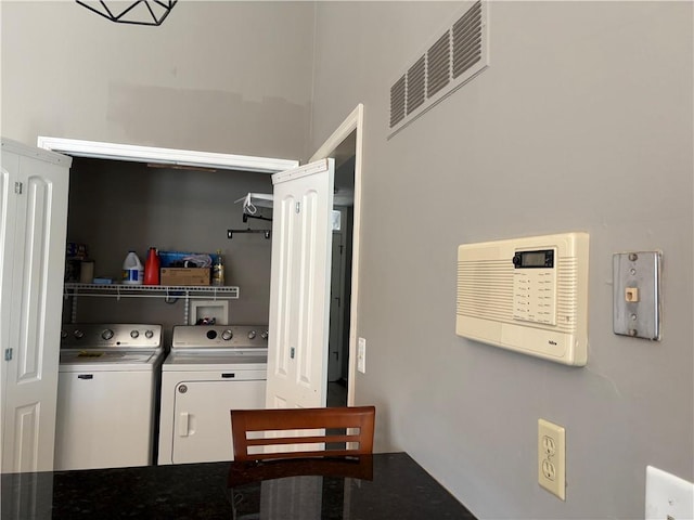 clothes washing area featuring laundry area, independent washer and dryer, and visible vents