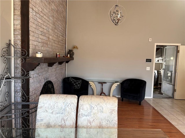 living area with a large fireplace and wood finished floors