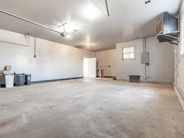 garage featuring electric panel and a garage door opener