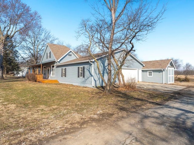 exterior space with a garage, a yard, and driveway