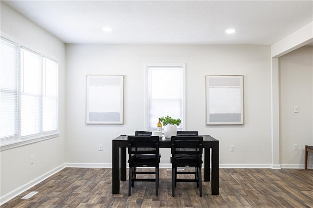 dining room featuring baseboards, dark wood-type flooring, a wealth of natural light, and recessed lighting