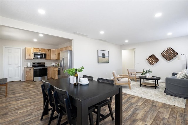 dining room featuring recessed lighting, dark wood-style flooring, visible vents, and baseboards