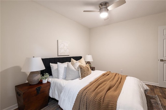 bedroom with wood finished floors, a ceiling fan, and baseboards