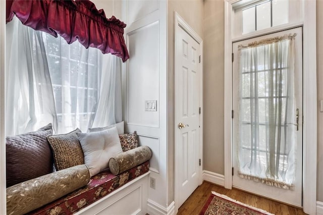 interior space featuring baseboards and wood finished floors