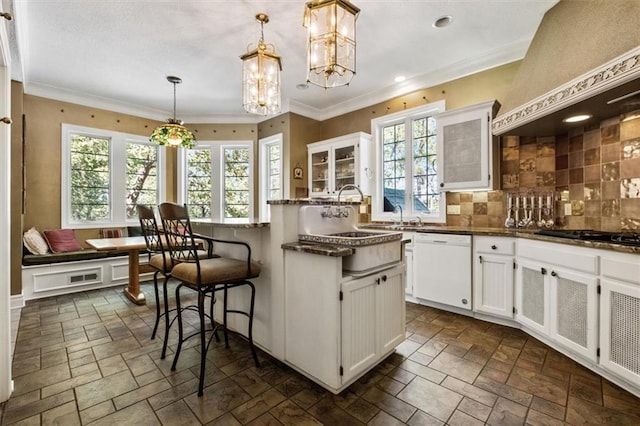 kitchen with custom exhaust hood, stone tile floors, breakfast area, black gas cooktop, and white dishwasher