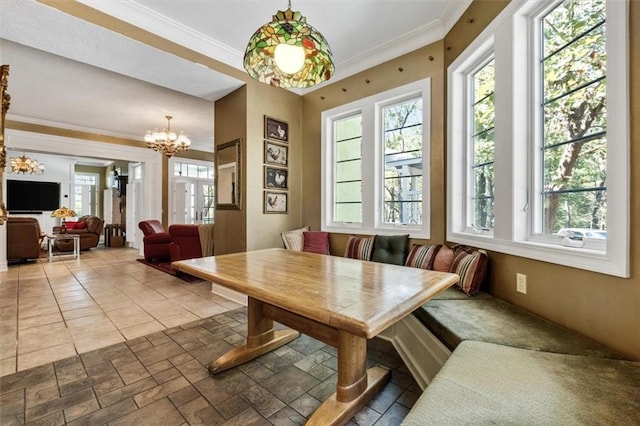 dining space with crown molding, breakfast area, and a wealth of natural light