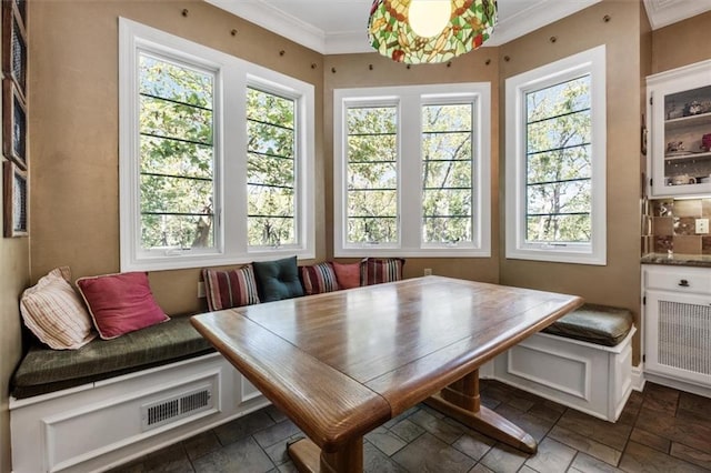 dining area with breakfast area, stone tile flooring, and visible vents